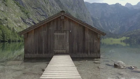 Close up through the pier to the house on the mountain lake Stock Footage 83524972