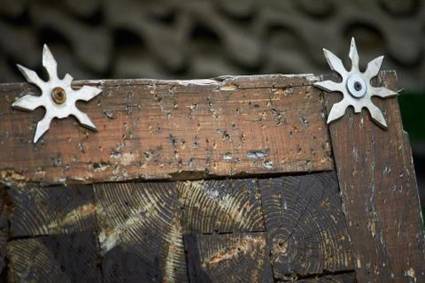 Close-up throwing board for throwing star decorated with broken shurikens, se Stock Photos