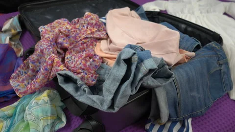 Close up of throwing clothes into a suitcase. Stock Footage 105624896
