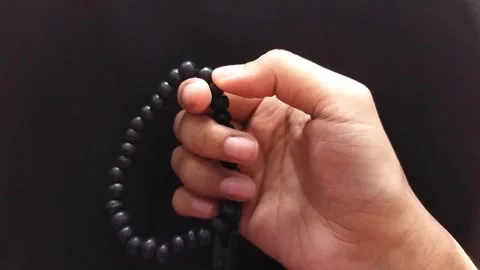 Close-Up of Thumb Moving Prayer Beads During Dhikr Stock Footage 325663009