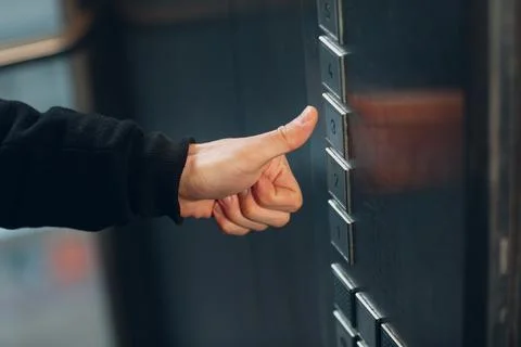 Close up of thumbs up pressing the button elevator during coronavirus pandemic Stockfoto's