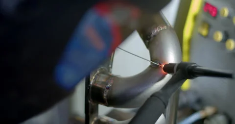 Close up tig welding.Car header pipe welding.Automotive exhaust pipe welding. Stock Footage 296338306