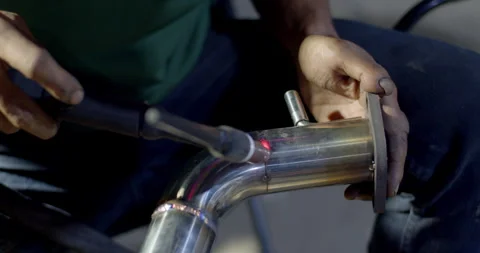 Close up tig welding.Car pipe welding.The hand of a mechanic or welder is fixing Stock Footage 287942507