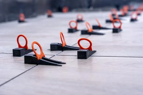 Close-up of the tile alignment system holding tile in given position Stock Photos