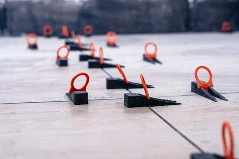 Close-up of the tile alignment system holding tile in given position Stock Photos