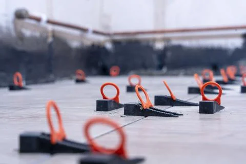 Close-up of the tile alignment system holding tile in given position Stock Photos