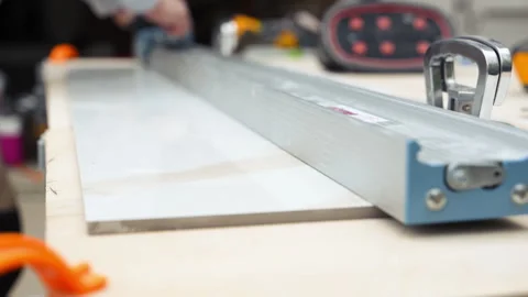 Close-up of an tile cutting machine slicing through a tile surface. precision Stock Footage 335949815