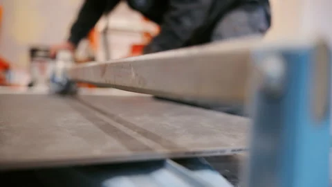 Close up of tile cutting machine in use during renovation work. Precision Stock Footage 334062852