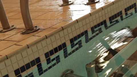 Close up of tiles and step ladder at public swimming pool Stock Footage 107625996