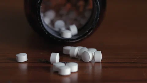 Close Up Tilt Across Pile of White Tablets on Table Stock Footage 341899475
