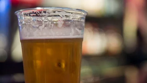 Close Up Tilt to Beer Picked Up in Bar Stock Footage 79537410