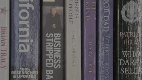 Close-Up Tilt of Business and Self-Help Books on Bookshelf Stock Footage 344603853