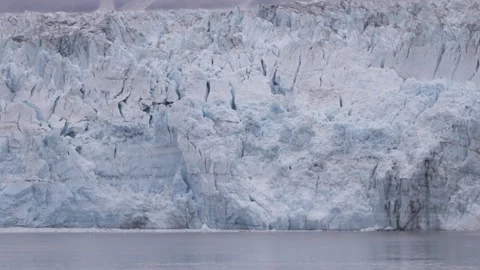 Close tilt up clip of the terminus face of hubbard glacier in alaska Stock Footage 345484617