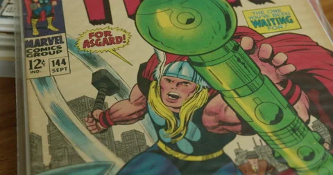 Close Up Tilt Down of a The Mighty Thor Comic Book Stock Footage 232109142