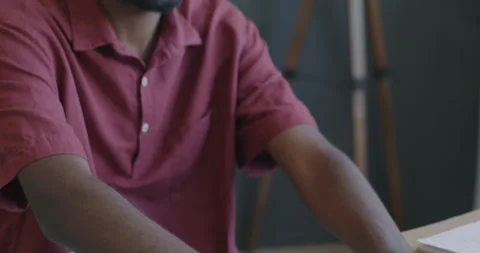 Close-up tilt-down portrait of African American employe working with laptop Stock Footage 247388311
