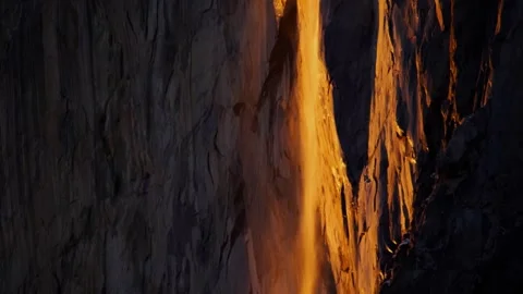 Close tilt up of firefall event in Yosemite National Park's Horsetail Falls. 스톡 동영상 331160178