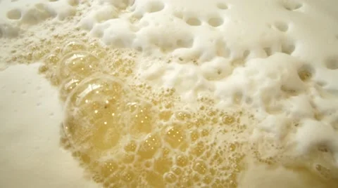 Close up tilt-out, bourbon mash fermenting with big bubbles Stock Footage
