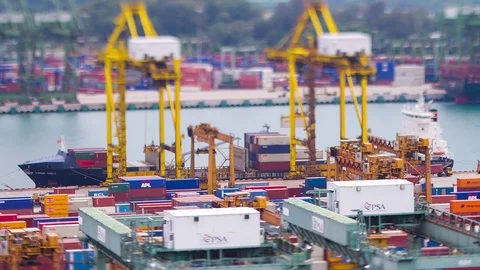 Close up Tilt-shift Timelapse of containers being loaded onto vessel at a port Stock Footage