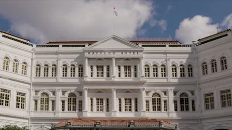Close tilt up shot of the front facade of the famous raffles hotel in singapore Stock Footage 256566646