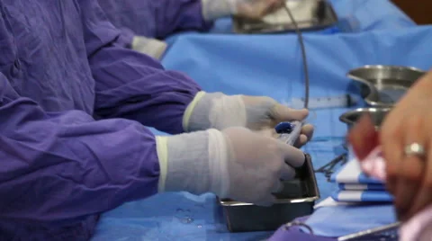 CLOSE UP-TILT UP. Surgeons preparing surgical instrumets for surgery. Stock Footage 48508023