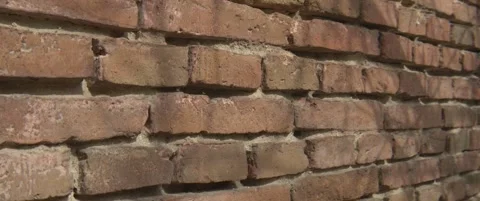 Close-up tilting on old bric wall texture 5.7K anamorphic video Stock Footage 304685318