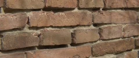 Close-up tilting on old brick wall surface anamorphic 5.7K video Stock Footage 303885348