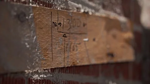 Close-up of timber formwork fixed to a brick wall with handwritten construction Stock Footage 337445409