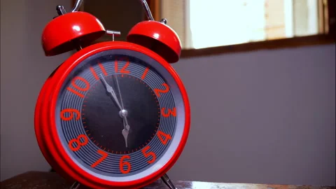 Close-Up Time-Lapse of Big Red Antique Alarm Clock on Wood by Open Window Stock Footage 337901178