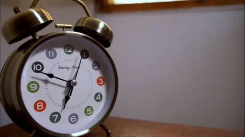 Close-Up Time-Lapse of a Chrome Vintage Alarm Clock on a Wooden Table Stock Footage 337194618