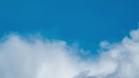 Close-up time lapse of clouds taken with a long lens. Blue sky with clouds 4K Stock Footage 197354620