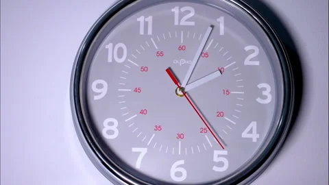 Close-Up Time-Lapse of a Gray Office Clock With Red Second Hand Stock Footage 337139313
