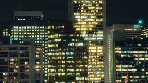 Close-Up Time-lapse of Illuminated Office Buildings at Night Stock Footage 296696720