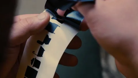 Close-up time-lapse of a man's hands tearing off excess paper Stock Footage 196834793