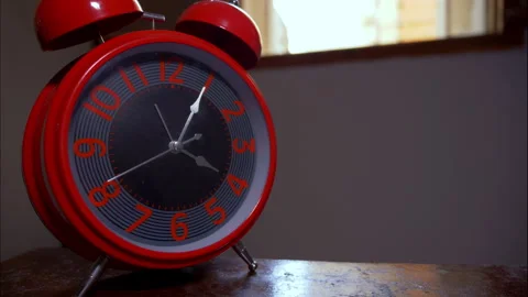 Close-Up Time-Lapse of a Red Vintage Alarm Clock by an Open Window 動画素材 337888065