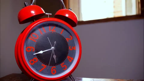 Close-Up Time-Lapse of a Red Vintage Alarm Clock by an Open Window Stock Footage 337901867