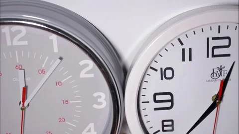 Close-Up Time-Lapse of Two Office Clocks on a White Background Stock Footage 337810724