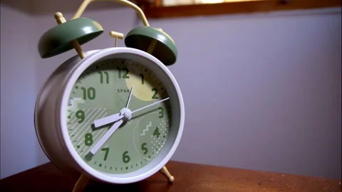 Close-Up Time-Lapse of a White and Green Antique Alarm Clock Right Angle Stock Footage 338293800