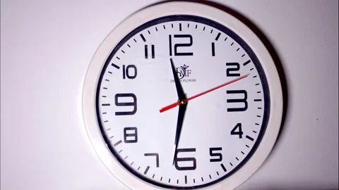 Close-Up Time-Lapse of White Circular Clock With Red Second Hand Stock Footage 337082314