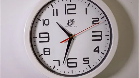 Close-Up Time-Lapse of a White Circular Clock With a Red Second Hand Stock Footage 337788592