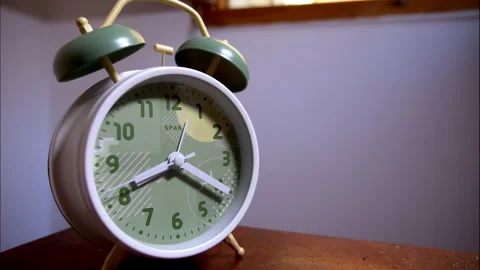 Close-Up Time-Lapse of a White Vintage Alarm Clock With Green Bells Stock Footage 338291133