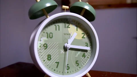 Close-Up Time-Lapse of a White Vintage Alarm Clock With Green Bells Stock Footage 338295918