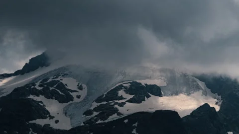 Close-up timelapse of summer storm clouds forming around Piz Ferrè Glacier Stock Footage 267280484