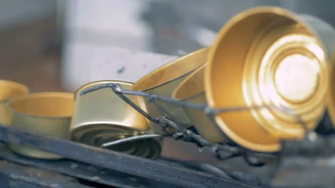 Close up of tin cans moving down a wireline and turning over Stock Footage 86375411