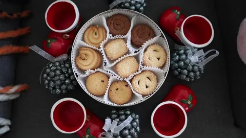 Close-up of a tin filled with assorted Danish butter cookies in decorative paper Stock Footage 294704700