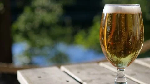 Close-up of tiny bubbles from a newly poured lager beer moving rapidly in Stock Footage 132934470