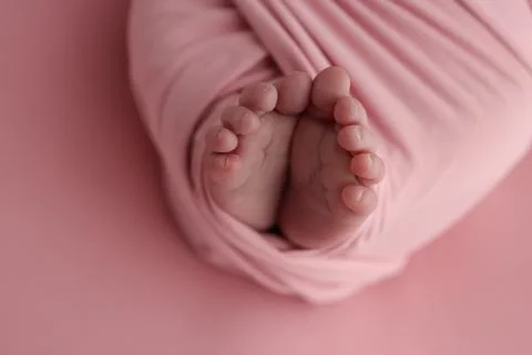 Close-up of tiny, cute, bare toes, heels and feet of a newborn girl, boy. Stock Photos