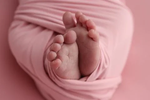 Close-up of tiny, cute, bare toes, heels and feet of a newborn girl, boy. Stock Photos