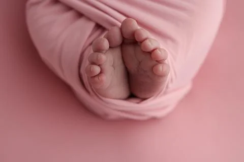 Close-up of tiny, cute, bare toes, heels and feet of a newborn girl, boy. Stock Photos