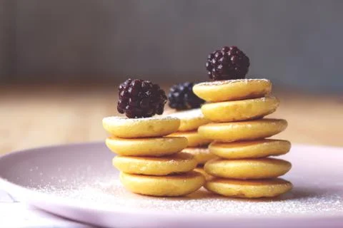 Close up of tiny pancakes with blackberries. Stock Photos