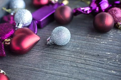 Close up of tiny silver sparkling Christmas ball. New year toys, hearts and Stock Photos
